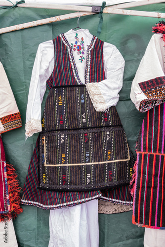 Traditional clothes for sale at an outdoor market.
