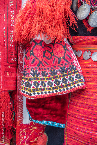Traditional clothes for sale at an outdoor market.