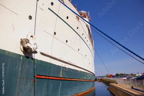 Side of an old ship permanently moored in a harbour