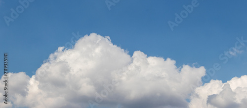 Panoramic blue sky with large white cumulus cloud on a sunny day