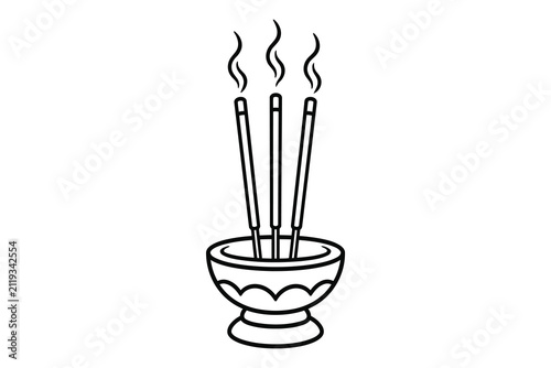 Three lit incense sticks in a traditional bowl