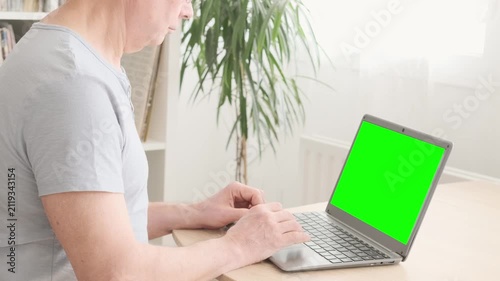elderly man hesitantly uses laptop, green screen mockup, representing challenges and opportunities digital literacy for seniors, Technology and Aging, Learning New Skills