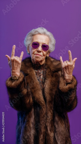 Cool grandmother posing in studio wearing fashionable clothes.