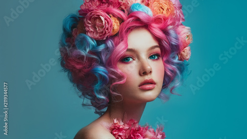Portrait of a girl with colorful hair and flowers in her hair.