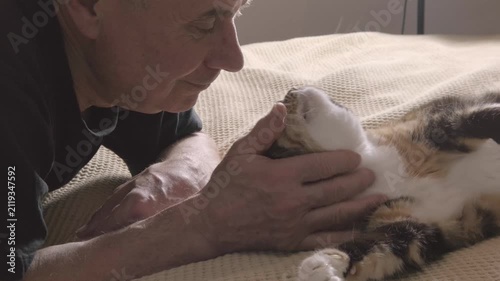 heartwarming scene mature man bonding with feline companion, finding comfort in each other's company, Human-animal bond