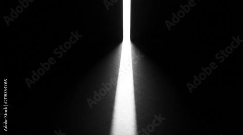 A bright beam of light shining through a narrow gap in a dark room