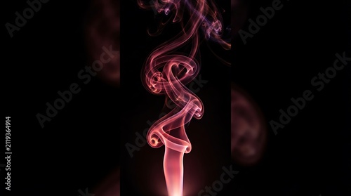 Elegant pink smoke gracefully swirling and forming an abstract feminine shape against a dark black background creating a mystical atmosphere