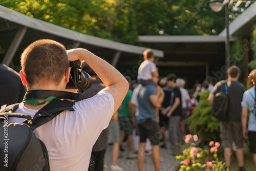 Bild auf Leinwand Photographer Covers an Outdoor Public Event