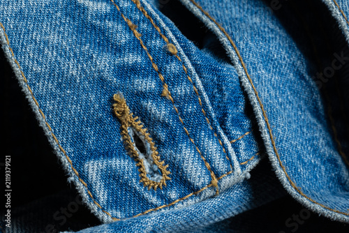 Foto Blue denim fabric texture with buttonhole detail