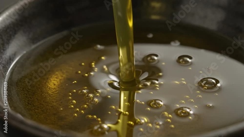 Premium Olive Oil Poured into Ceramic Bowl in Macro Close Up
