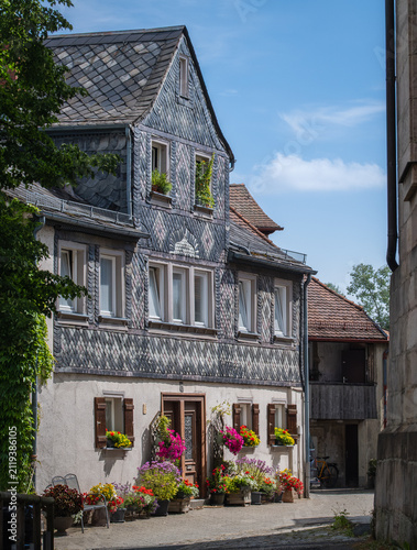 Furth, Germany - 15 July 2026: View of a historic half-timbered house with slate cladding and colorful flower boxes in the old town.