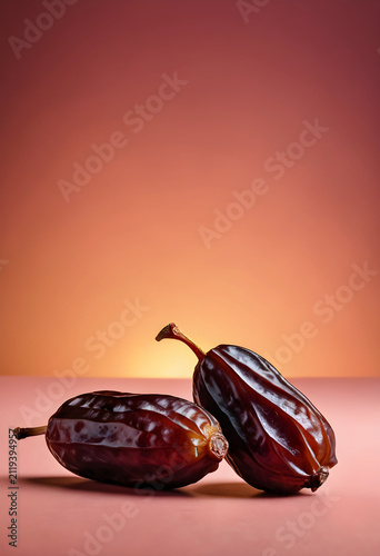 Two dried dates with stems ...