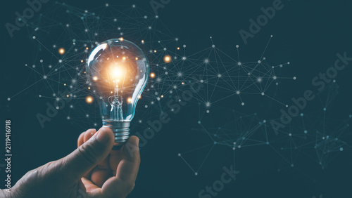 Innovation and creative technology concept. Glowing light bulb connected to digital network. Ai, inspiration, brainstorming, smart solutions, knowledge sharing and future digital transformation.