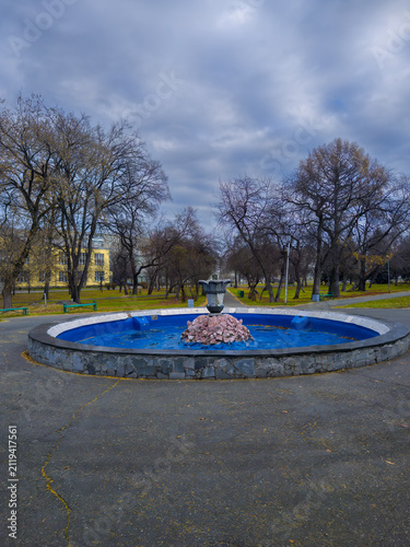 Non-functioning fountain in autumn park