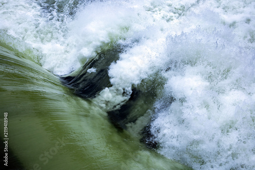 Scenic view of the Snake River flowing through Idaho Falls, Idaho, featuring peaceful river waters, cascading waterfalls, lush green riverbanks, and the natural beauty of eastern Idaho. 