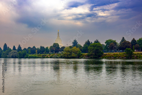 Beautiful exterior view of the Idaho Falls Idaho Temple of The Church of Jesus Christ of Latter-day Saints, featuring its distinctive white spire, elegant architecture, and peaceful grounds along the 