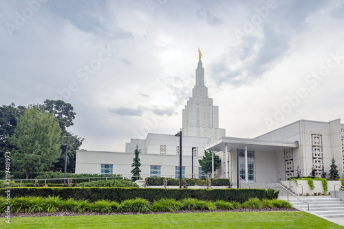 Beautiful exterior view of the Idaho Falls Idaho Temple of The Church of Jesus Christ of Latter-day Saints, featuring its distinctive white spire, elegant architecture, and peaceful grounds along the 