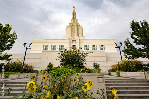 Beautiful exterior view of the Idaho Falls Idaho Temple of The Church of Jesus Christ of Latter-day Saints, featuring its distinctive white spire, elegant architecture, and peaceful grounds along the 