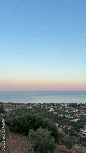 Palamutbükü Datça aerial view, dramatic cliffs, crystal-clear blue sea, almond trees, vast sky, stunning Mediterranean coastline