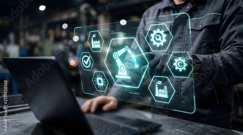 Industrial engineer controlling robotic automation system in modern manufacturing environment