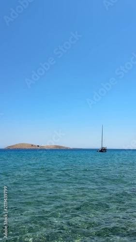 Palamutbükü Datça, crystal-clear turquoise sea, glass-like water, white sailboat, peaceful Mediterranean coast, cinematic summer view