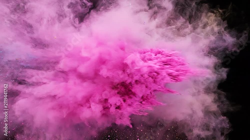 Overlay video transition, Vibrant multicolored powder explosion featuring blue, pink, and yellow hues against a dark black background.