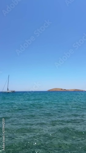 Palamutbükü Datça, crystal-clear turquoise sea, glass-like water, white sailboat, peaceful Mediterranean coast, cinematic summer view