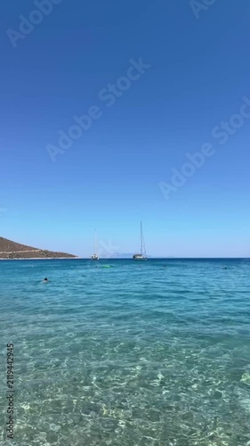Palamutbükü Datça, endless deep blue sea, crystal-clear water, sailboat near the shore, rocky Mediterranean coastline, serene summer atmosphere
