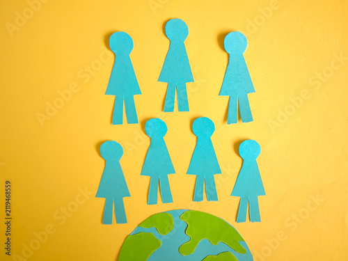 World Population Day Concept with Paper Cut Globe and People Figures on Yellow Background. Save the world.