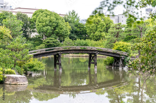 Traditional Japanese garden with wooden bridge