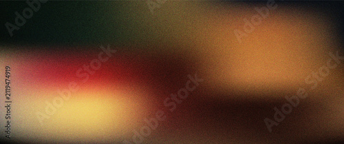 Abstract dark soft blurred gradient background with grain texture and warm orange and brown tones
