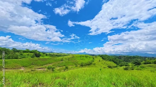 Timelapse of tropical green hills under dramatic blue sky in Flores, Indonesia