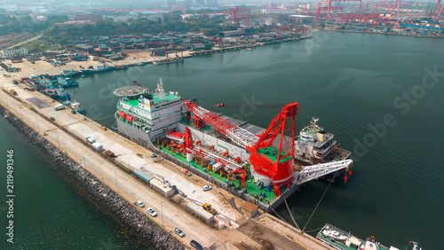 Canvas Print Large Crane Vessel Docked at Coastal Port Facility