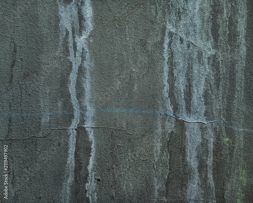 Dark gray weathered concrete wall texture with water drip stains and vintage grunge effect. 