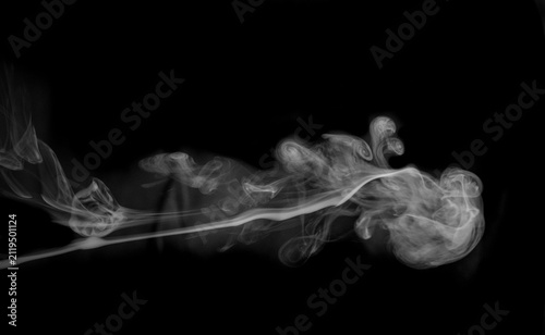 фотографія A large, billowy mass of white smoke dominates the frame, its soft, undulating forms and delicate wisps creating a dramatic and ethereal presence against the stark black canvas