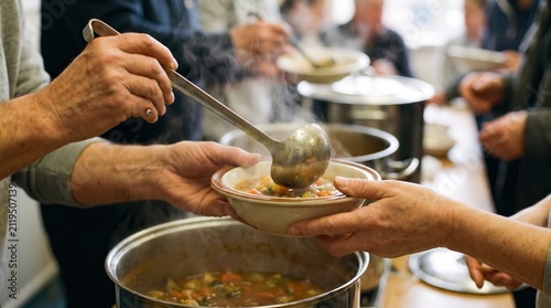 leadership development nonprofits volunteer concept. Soup being served from large pots into a bowl at a communal meal event