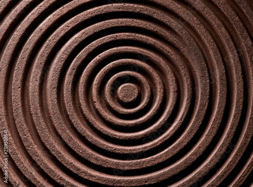 Concentric ridged brown chocolate circles forming a hypnotic spiral pattern