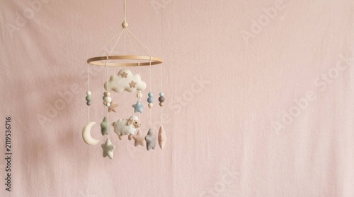 Soft Felt Baby Mobile with Sheep and Stars Hanging in a Nursery for Newborn Sleep