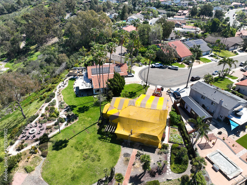 Aerial view of Termite fumigation tent, whole-structure treatment process that involves sealing a building in a tarp, releasing a lethal gas, and aerating the property