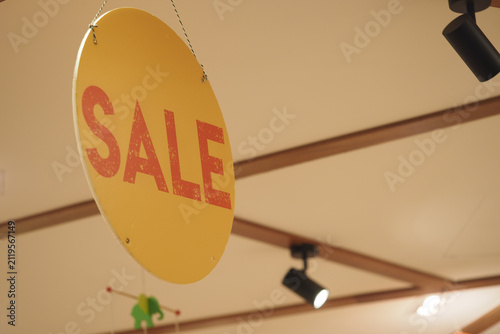 Foto Sign shows sale in a store with yellow background