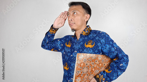 Photography Young male civil servant making a salute pose while holding important document i