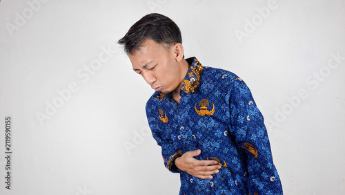 Cuadro en lienzo Young handsome male civil servant having a stomachache and painful expression in
