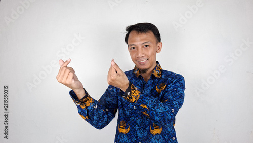 Photography Young handsome male civil servant making heart sign using his fingers
