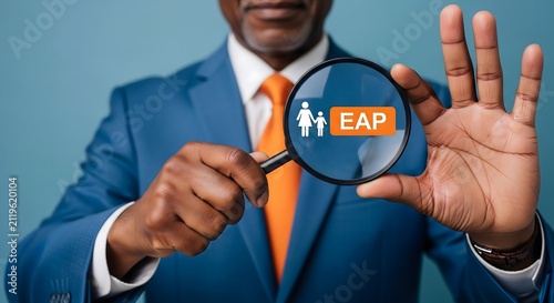 Professional businessman holding magnifying glass showing EAP employee assistance program