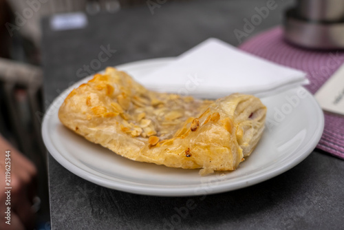 Almond pastry on a white plate with a napkin.