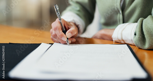 Fotografie Documents, signature and hands of woman in office for health insurance claim with application