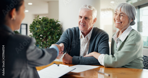 Smile, old couple and handshake at house with advisor, real estate deal and purchase agreement. Senior people, shaking hands or thank you for consultation, retirement benefits and finance negotiation