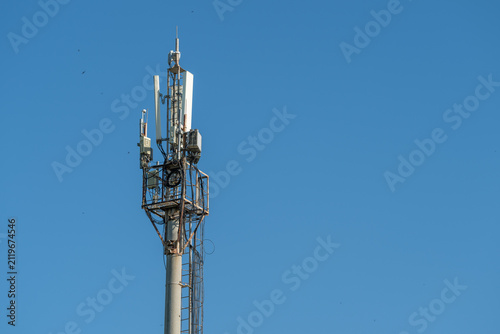 Cuadro en lienzo Telecommunication tower with panel antennas and support hardware rising against
