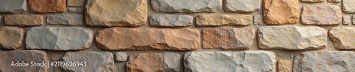 Panoramic view of a wide, naturally textured pebble-dashed stone wall , photography, wide shot