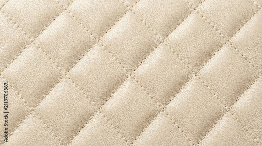 Obraz premium Close up of beige quilted leather texture with diamond pattern and visible generated using ai